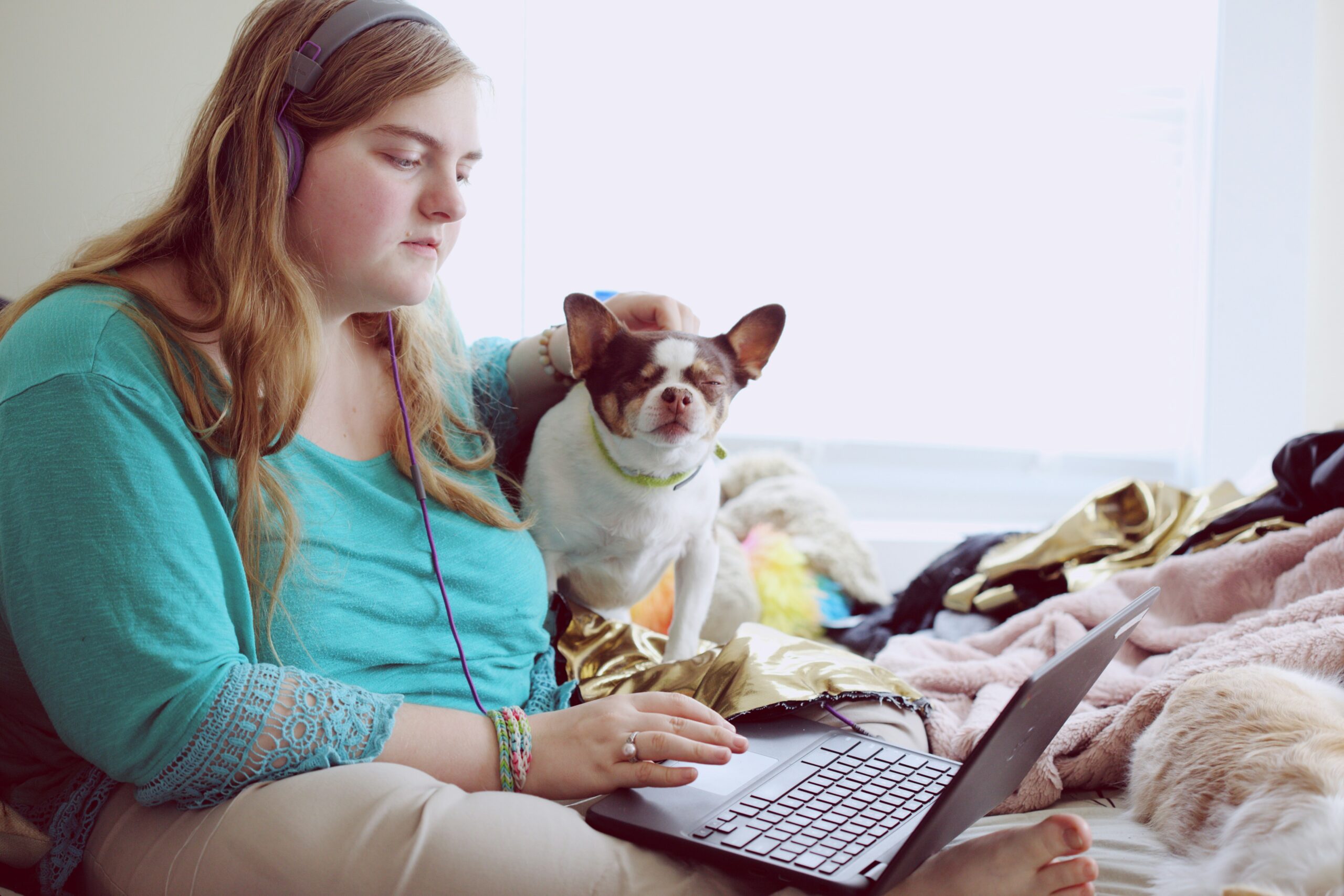 A 19-year-old woman with Autism and other learning disabilities using her laptop at home.